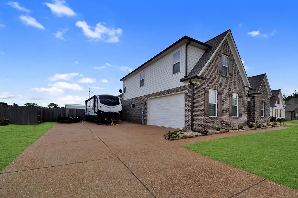 70 Trinity Cove Atoka, TN 38004 - Photo 19 of 20 a front view of a house with garden