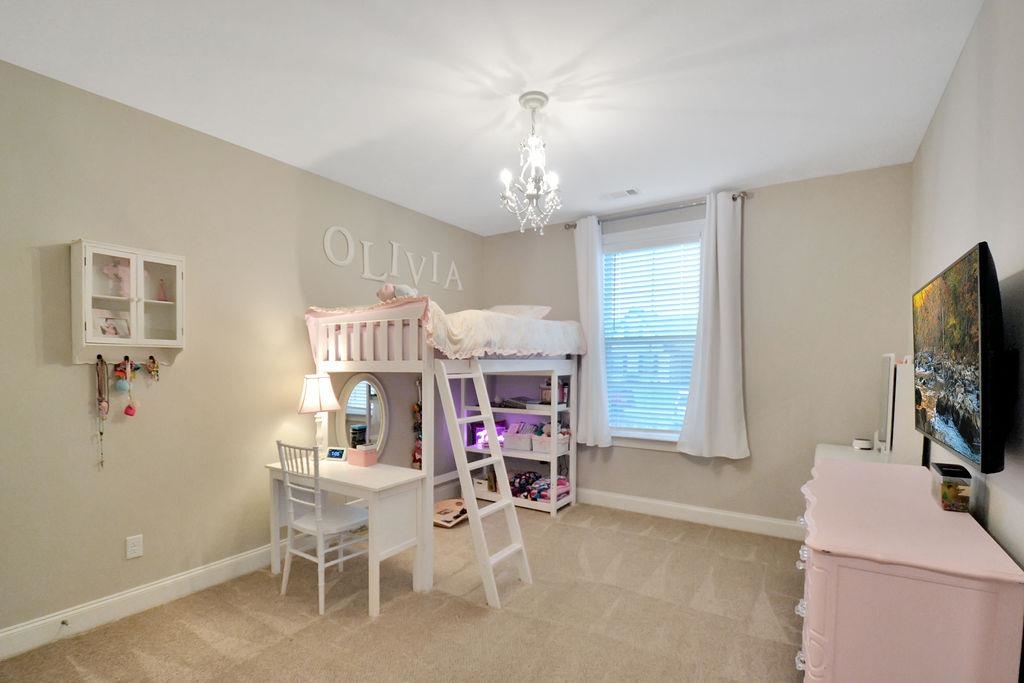 70 Trinity Cove Atoka, TN 38004 - Photo 10 of 20 a living room with furniture a flat screen tv and a window