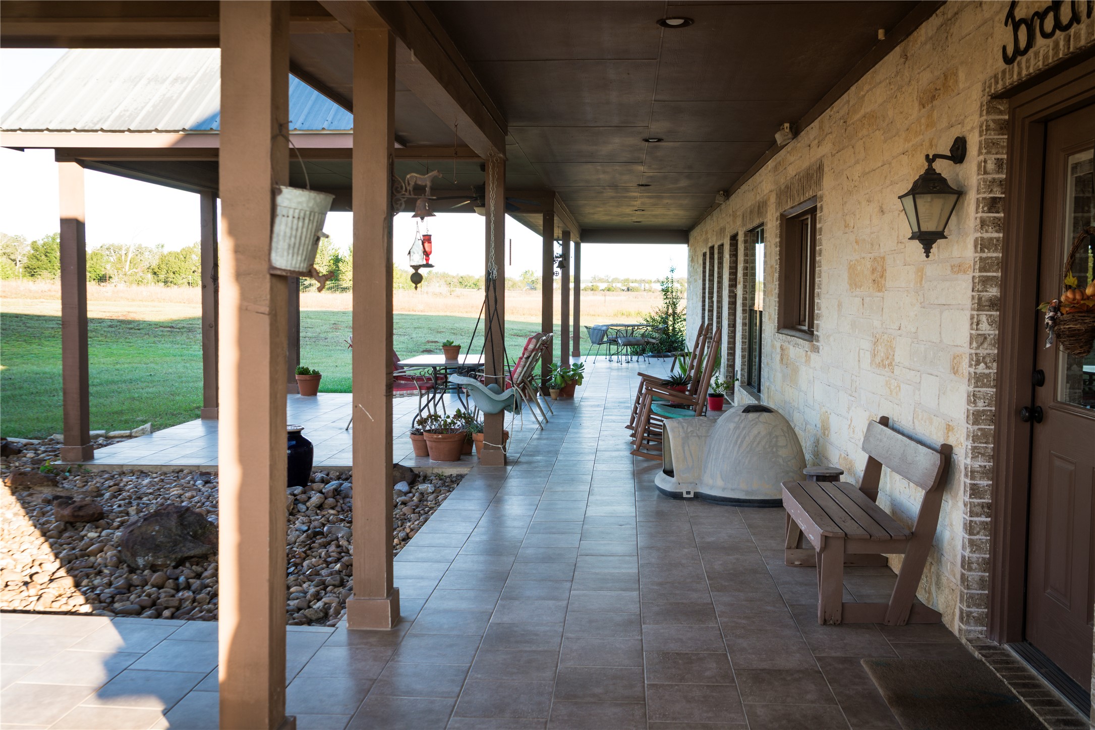 298 Cr 346 Road Milano, TX 76556 - Photo 22 of 26 a view of a patio with table and chairs potted plants with wooden floor