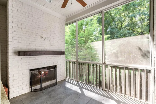 a living room with a fireplace and a floor to ceiling window