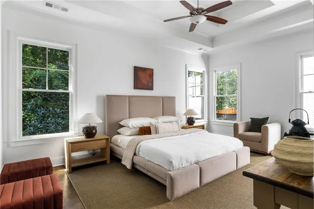 a bedroom with a bed couches and a window