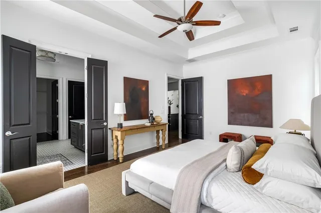 a bedroom with a bed and wooden floor