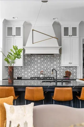 a kitchen with a sink and a potted plant