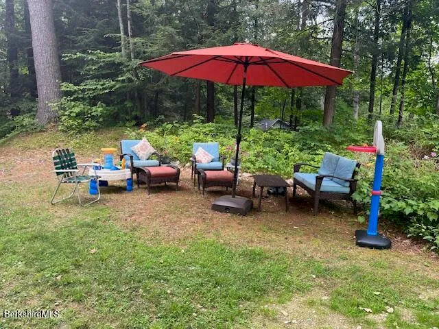 a view of a backyard with a patio and garden