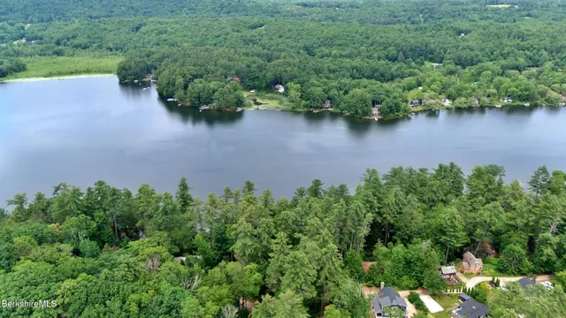an aerial view of a houses with outdoor space and lake view