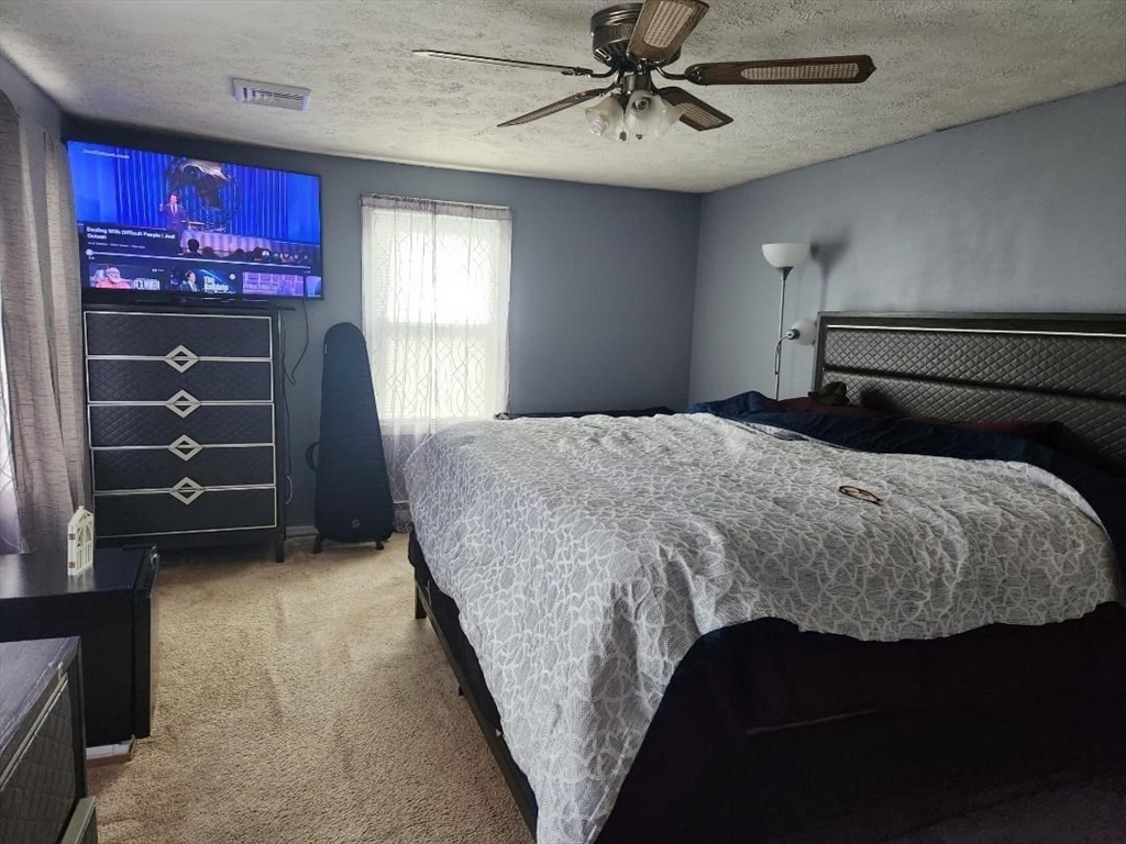 21 Brattle Street Worcester, MA 01606 - Photo 2 of 14 a bedroom with a bed and a window