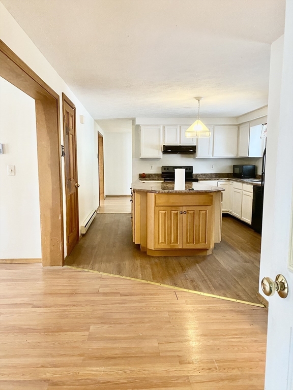 21 Brattle Street Worcester, MA 01606 - Photo 7 of 14 a view of kitchen with kitchen island microwave and cabinets