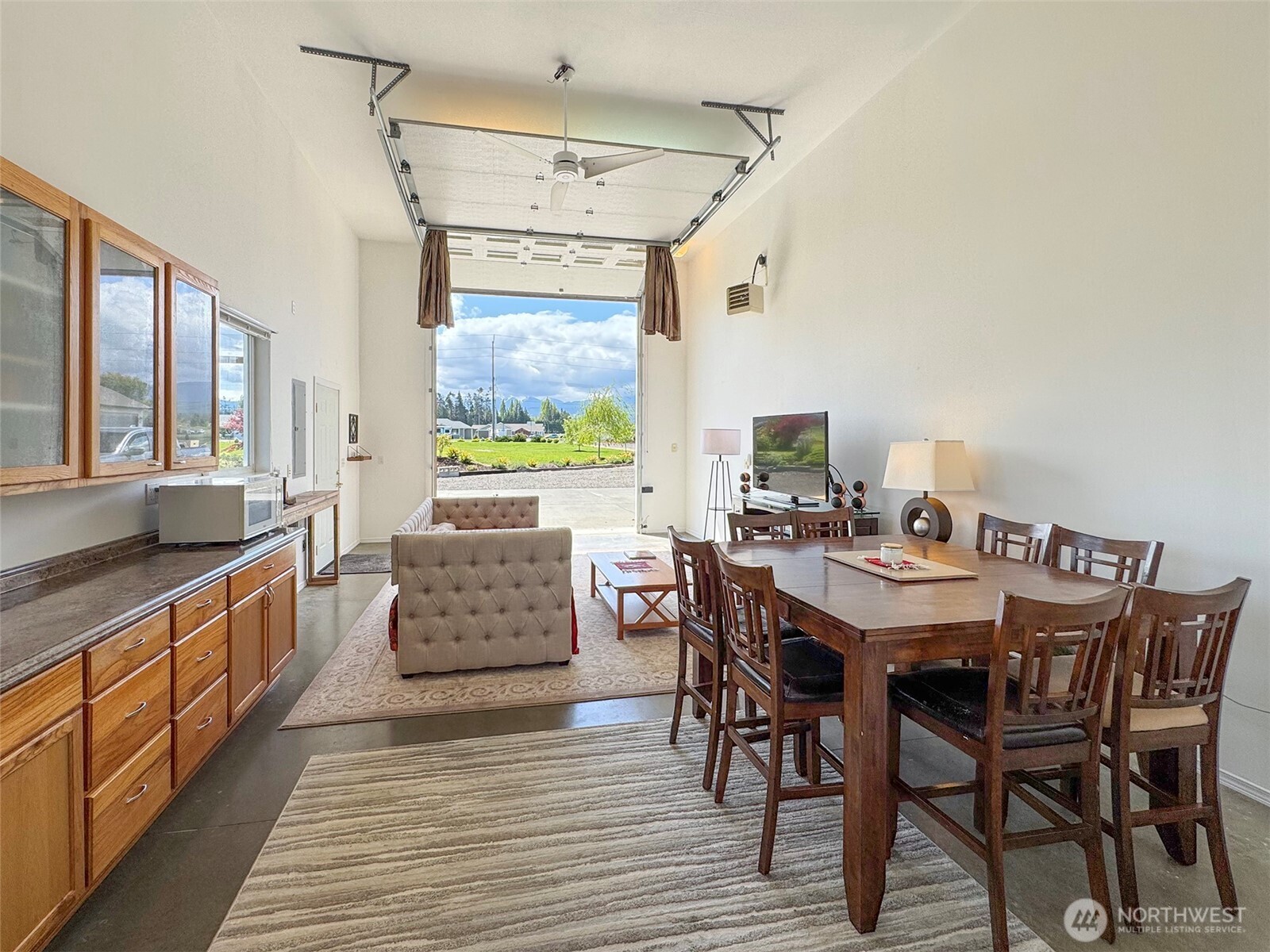 152 Macleay Road Sequim, WA 98382 - Photo 19 of 40 a kitchen with stainless steel appliances granite countertop a dining table chairs and a refrigerator