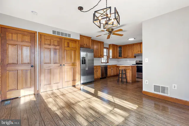 a view of a kitchen with a sink wooden floor and a window