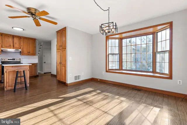 a view of a room with a window and wooden floor