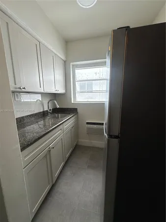 a kitchen with a sink stove and refrigerator