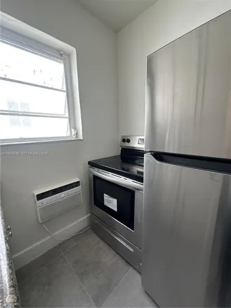 a kitchen with appliances and a window