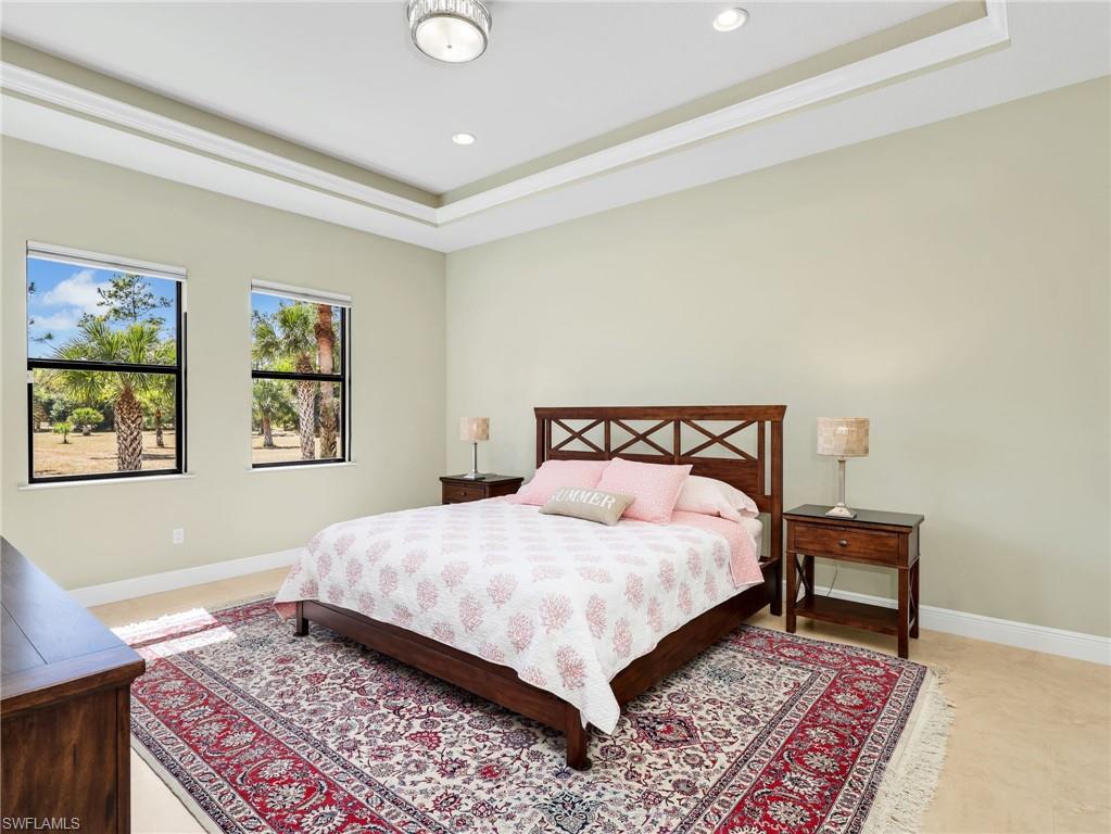 3160 27th Avenue Southwest Naples, FL 34117 - Photo 18 of 43 a bed sitting in a bedroom next to a window