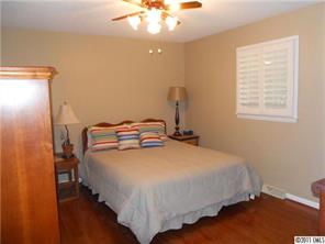3932 Lake Shore Road South Denver, NC 28037 - Photo 13 of 16 a bedroom with a bed and a chandelier