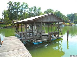 3932 Lake Shore Road South Denver, NC 28037 - Photo 5 of 16 a small pool with a table and chairs under an umbrella