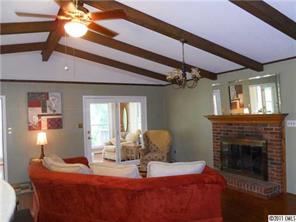 3932 Lake Shore Road South Denver, NC 28037 - Photo 7 of 16 a dining room with a fireplace and chandelier