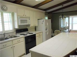 3932 Lake Shore Road South Denver, NC 28037 - Photo 8 of 16 a kitchen with a refrigerator a stove a sink and a cabinets