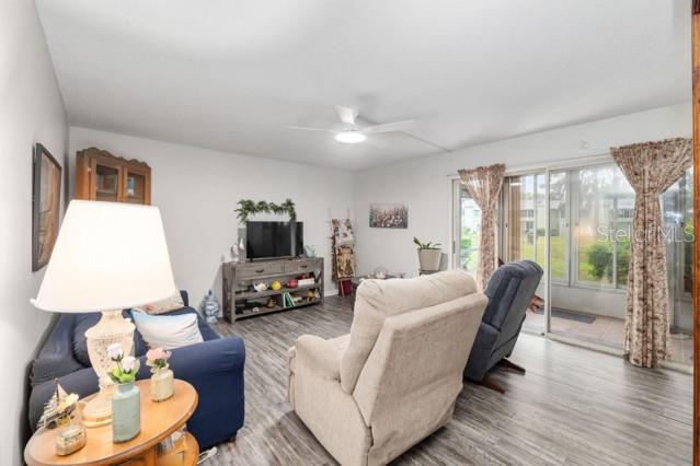 631 Silver Pass, Unit A Ocala, FL 34472 - Photo 12 of 47 a living room with furniture and a flat screen tv