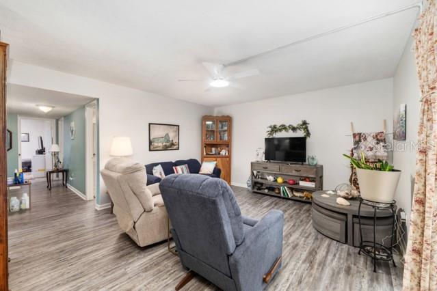 631 Silver Pass, Unit A Ocala, FL 34472 - Photo 13 of 47 a living room with furniture and a flat screen tv with wooden floor