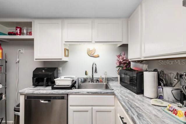 631 Silver Pass, Unit A Ocala, FL 34472 - Photo 21 of 47 a kitchen with sink and cabinets