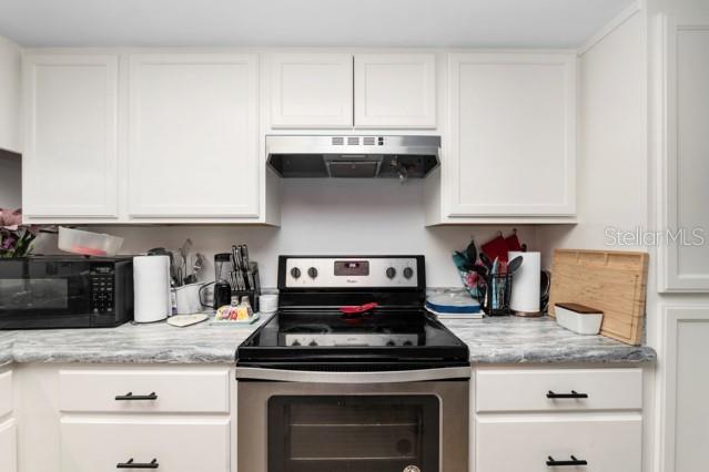 631 Silver Pass, Unit A Ocala, FL 34472 - Photo 24 of 47 a stove top oven sitting inside of a kitchen