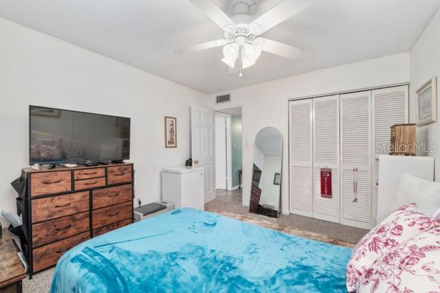 631 Silver Pass, Unit A Ocala, FL 34472 - Photo 26 of 47 a bedroom with a bed and a flat screen tv in it