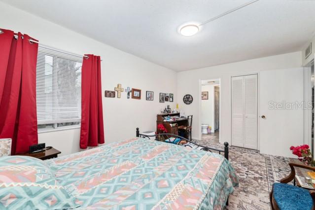 631 Silver Pass, Unit A Ocala, FL 34472 - Photo 29 of 47 a bed room with a bed and a chair