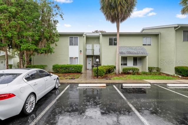 631 Silver Pass, Unit A Ocala, FL 34472 - Photo 3 of 47 a front view of a house with garden and parking space