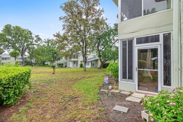 631 Silver Pass, Unit A Ocala, FL 34472 - Photo 39 of 47 a view of a yard with plants and trees