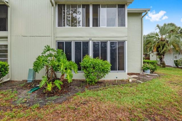 631 Silver Pass, Unit A Ocala, FL 34472 - Photo 41 of 47 a view of a house with a small yard and plants