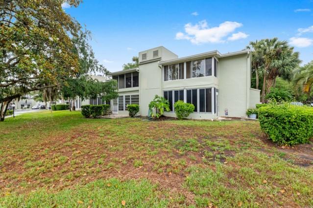 631 Silver Pass, Unit A Ocala, FL 34472 - Photo 44 of 47 a view of a house with a big yard and large trees