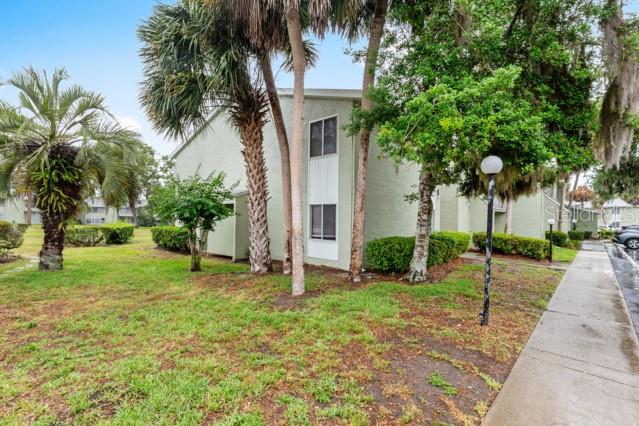 631 Silver Pass, Unit A Ocala, FL 34472 - Photo 46 of 47 a house with palm tree in front of it