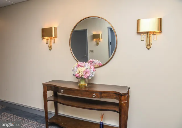 a room with painting on wall and a mirror