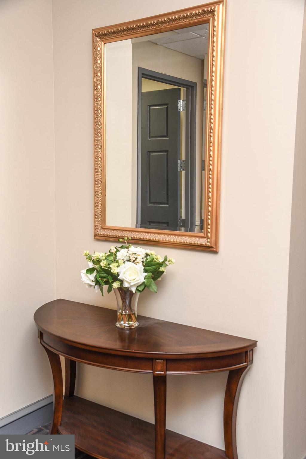 1811-19 Chestnut Street, Unit 404 Philadelphia, PA 19103 - Photo 15 of 17 a view of a hallway with chair and wooden floor