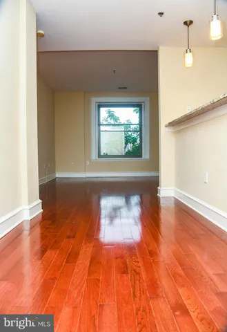 a view of a room with wooden floor and large window
