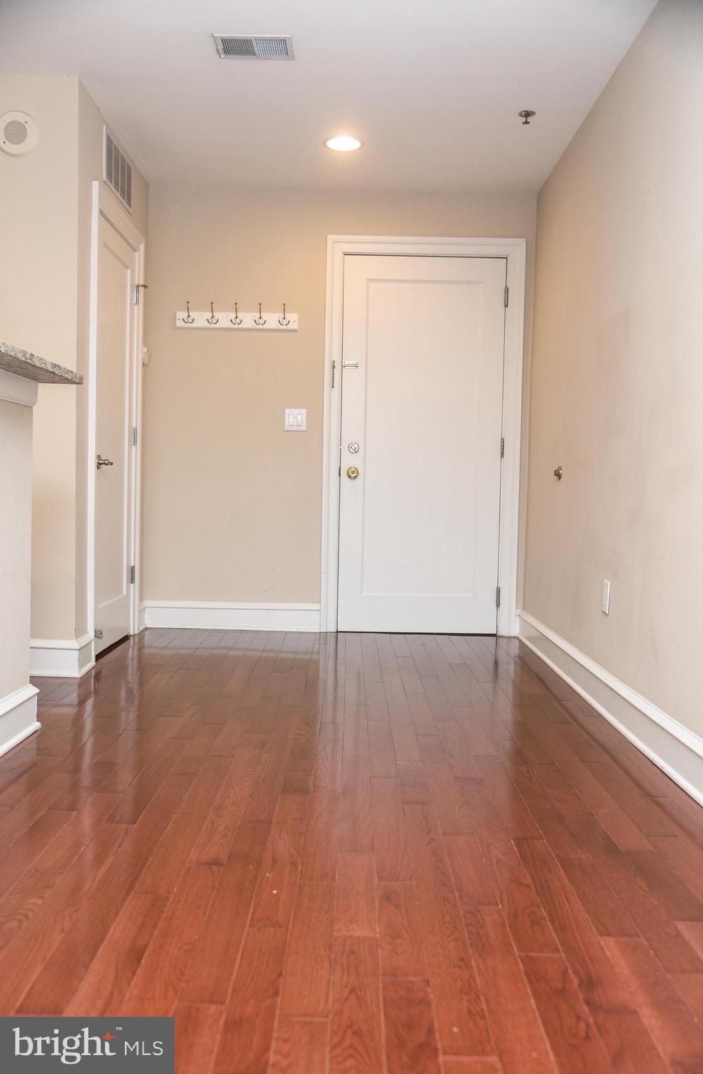 1811-19 Chestnut Street, Unit 404 Philadelphia, PA 19103 - Photo 10 of 17 a view of an empty room with wooden floor and a window