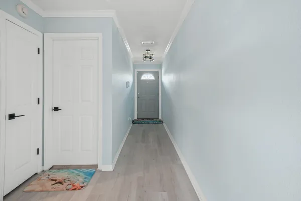 a view of a hallway with wooden floor