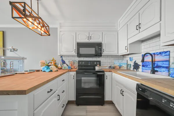 a kitchen with stainless steel appliances a sink stove and cabinets