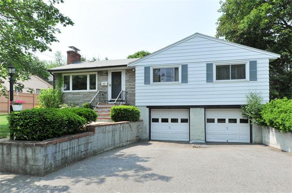 24 Browning Road Arlington, MA 02476 - Photo 1 of 1 a front view of a house with a garden and plants