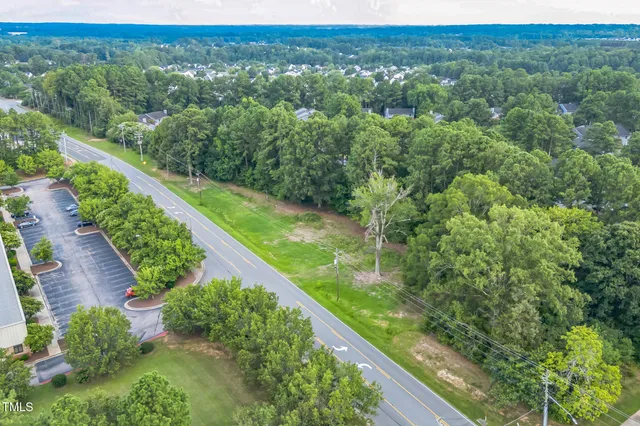 a view of a green field with lots of trees