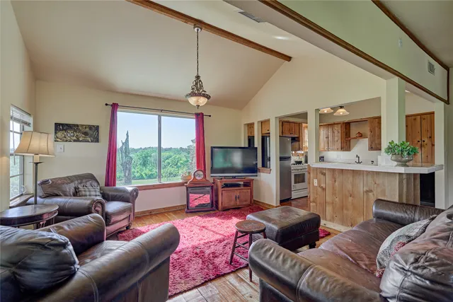 a view of a livingroom with hardwood floor and a ceiling fan