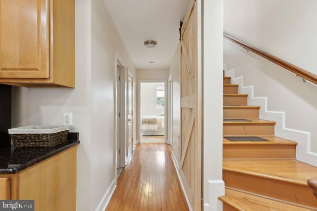 a view of a kitchen with wooden floor and cabinets
