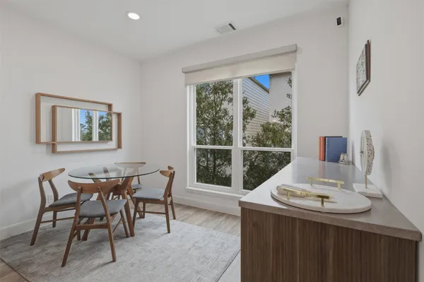 a dining room with a table and chairs