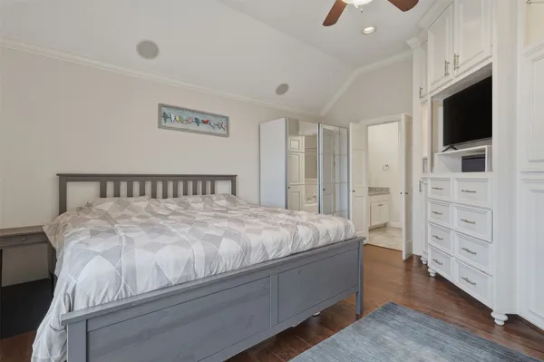 a spacious bedroom with a bed and flat screen tv
