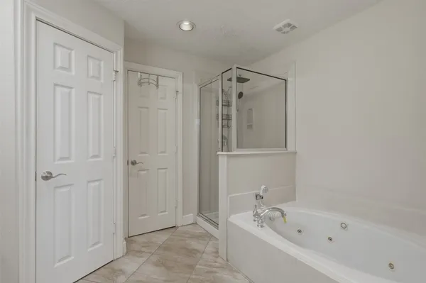 a bathroom with a bathtub and a shower