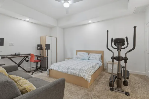 a bedroom with furniture and a gym equipment