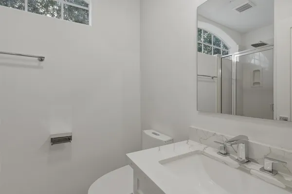 a bathroom with a sink toilet and shower