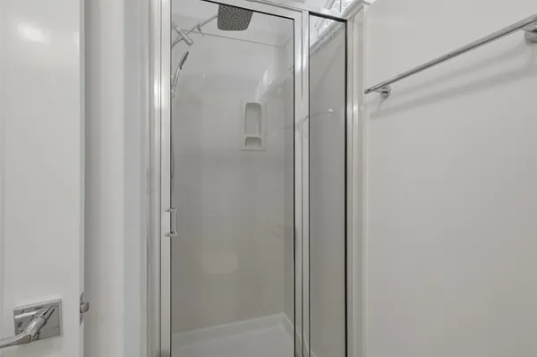 a bathroom with a glass shower door