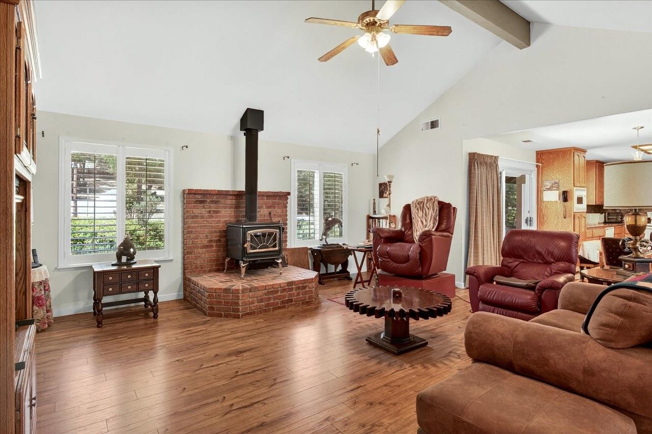 38090 Wortham Road Oakhurst, CA 93644 - Photo 11 of 54 a living room with furniture a fireplace and wooden floor