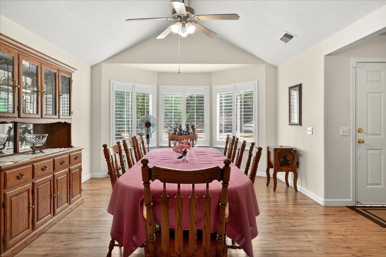 38090 Wortham Road Oakhurst, CA 93644 - Photo 12 of 54 a view of a a dining room with furniture window and wooden floor